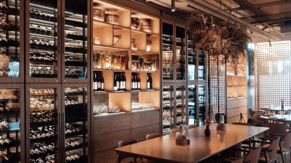Stylish wine bar with display cases and wine bottles in Cologne city centre